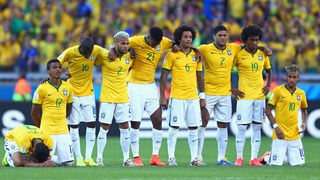Brazil players look on preparing for penalty kicks