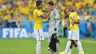 Luiz Gustavo of Brazil speaks to goalkeeper Julio Cesar before penalty kicks