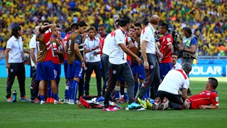 Chile players rest before the extra time during the 2014 FIFA World Cup Brazil Round of 16 match