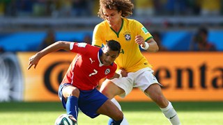 Alexis Sanchez of Chile and David Luiz of Brazil compete for the ball