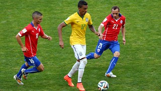 Luiz Gustavo of Brazil controls the ball against Felipe Gutierrez (L) and Marcelo Diaz of Chile