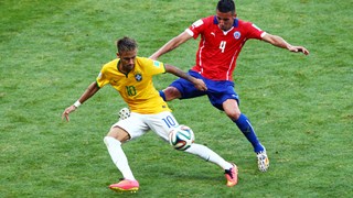 Neymar of Brazil and Mauricio Isla of Chile compete for the ball