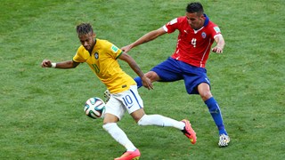 Neymar of Brazil controls the ball as Mauricio Isla of Chile gives chase