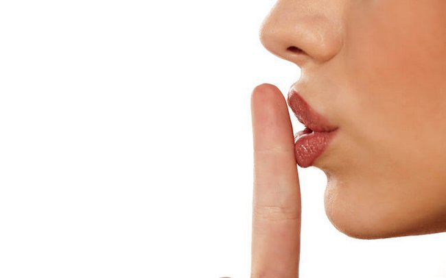 finger on her lips. silence gesture