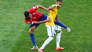 Neymar of Brazil and Mauricio Isla of Chile compete for the ball